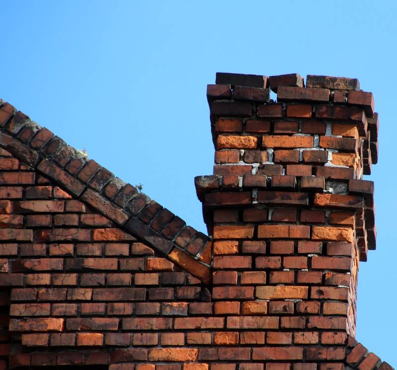 Signs Your Harvard Home Needs a Chimney Inspection Damaged chimney on an Harvard home showing cracks and missing mortar